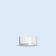 clear Tea Light plastic candle container on light blue background